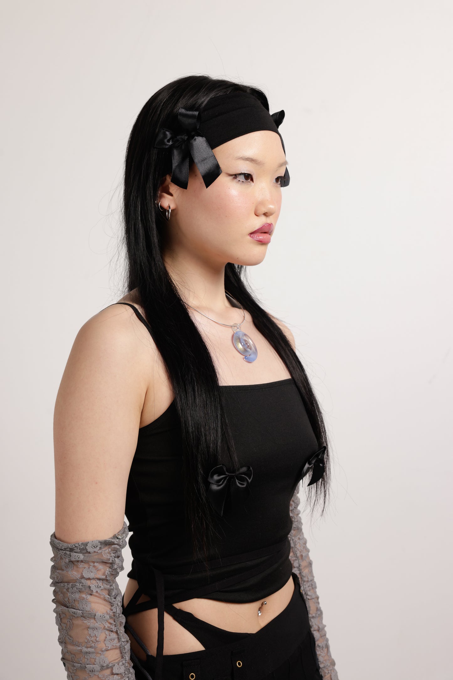 girl wearing black headband with two black bows on both side and blue spiral necklace | Let's Spiral Charm | Baobei Label