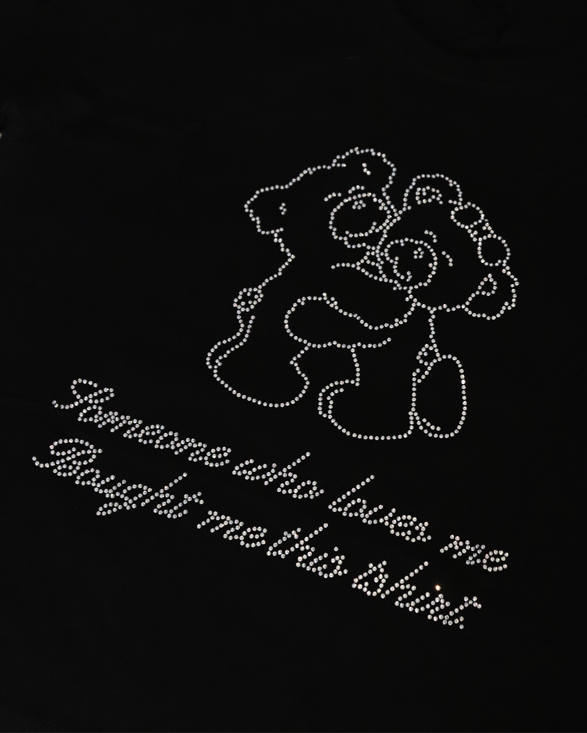 close up of black tee shirt with rhinestone writing 'someone who loves me bought me this tshirt' and two bears hugging | Teddy Tee in Black | Baobei Label