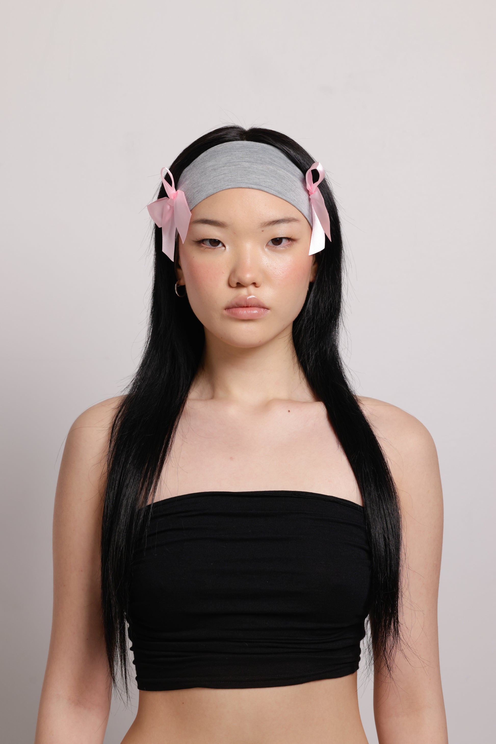 girl wearing grey headband with two pink bows on both side | Bow Me a Kiss | Baobei Label | Headband