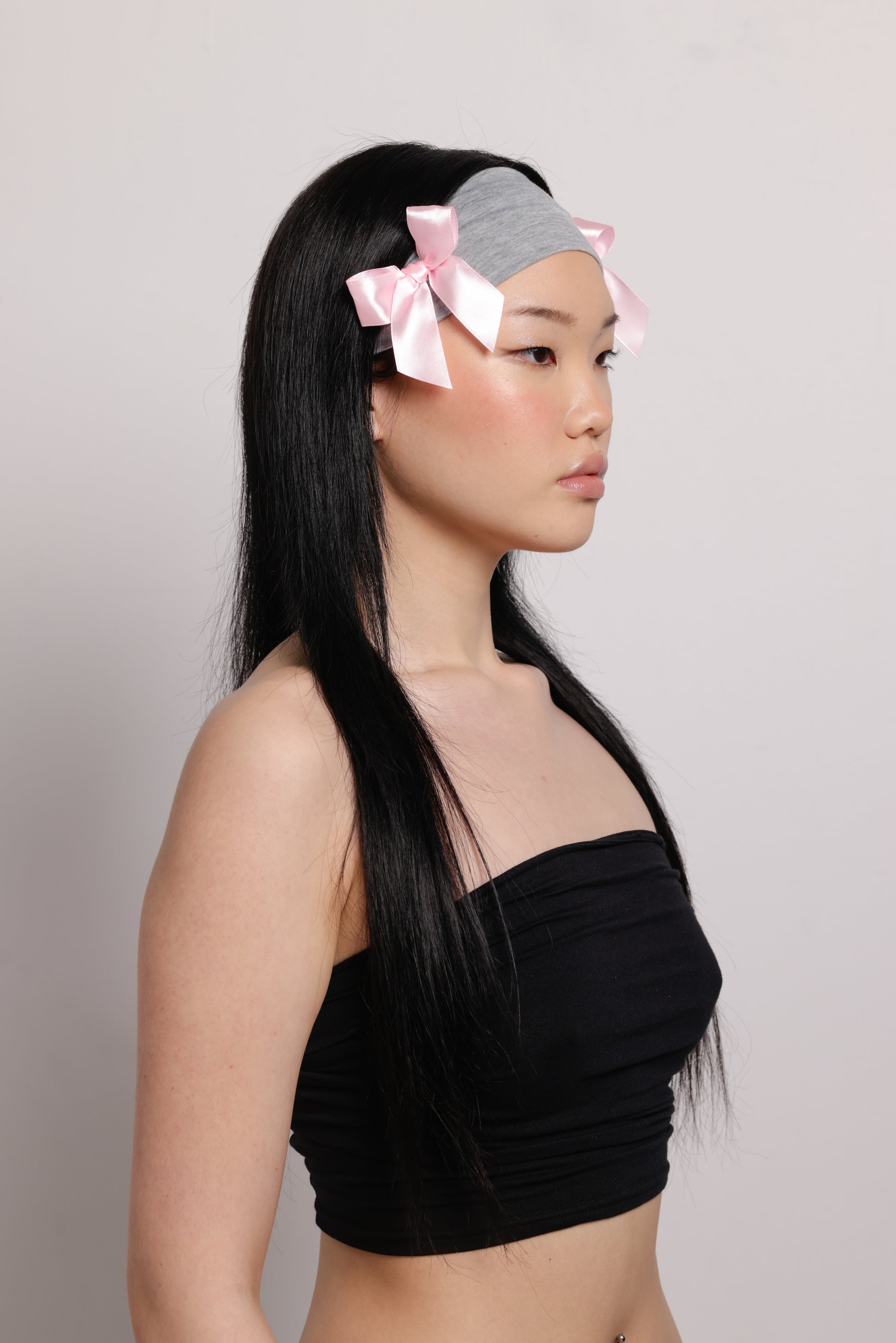 girl wearing grey headband with two pink bows on both side | Bow Me a Kiss | Baobei Label | Headband