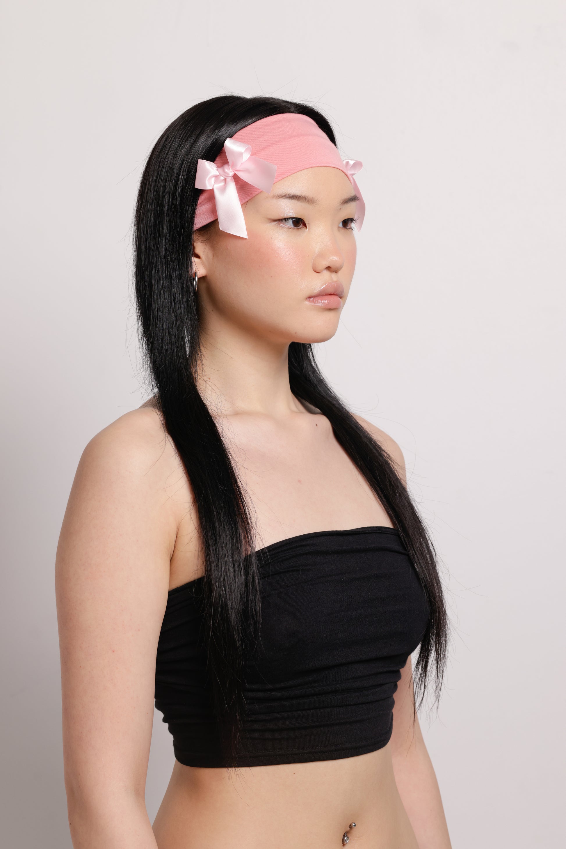 girl wearing pink headband with two pink bows on both side | Bow Me a Kiss | Baobei Label | Headband | Buttermilk Accessories