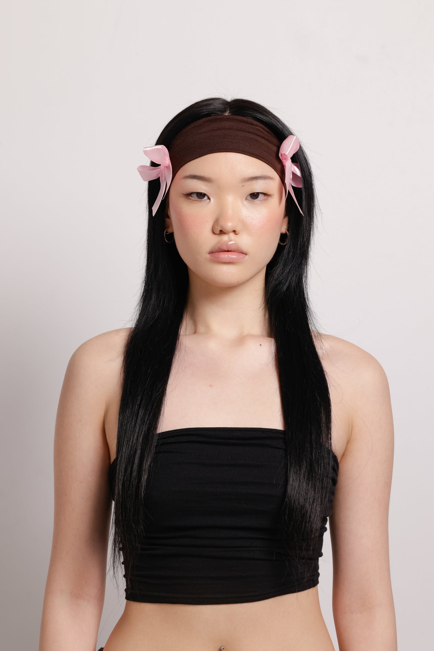 girl wearing brown headband with two pink bows on both side | Bow Me a Kiss | Baobei Label | Headband | Buttermilk Accessories